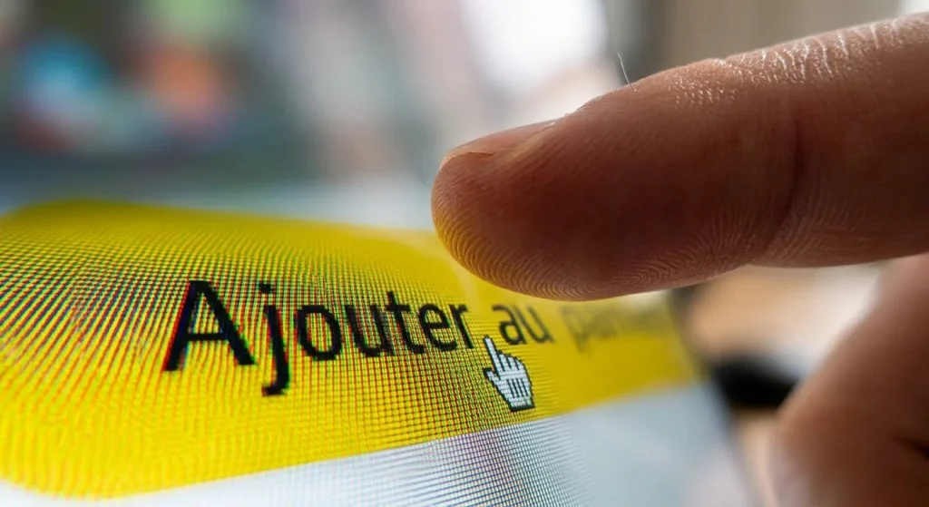 Gros plan sur un doigt s'apprêtant à cliquer sur le célèbre bouton jaune Ajouter au panier d'un écran, symbolisant le fonctionnement caché de la Buy Box sur Amazon.